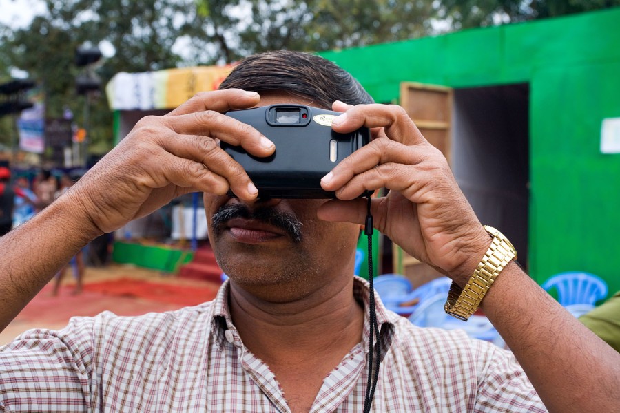 An Indian tourist photographs with his camera pointed at himself